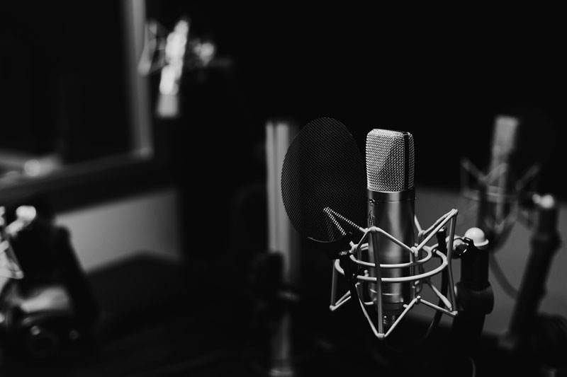 A microphone on a stand in a studio