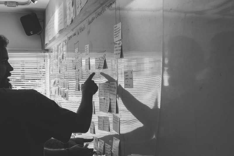 Person pointing at a post-its on a mood board